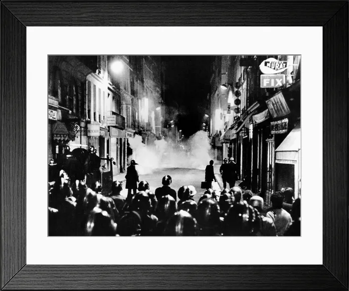 Framed Print : Riot policemen at a burning barricade on the Rue de Seine, a narrow Latin Quarter side street
