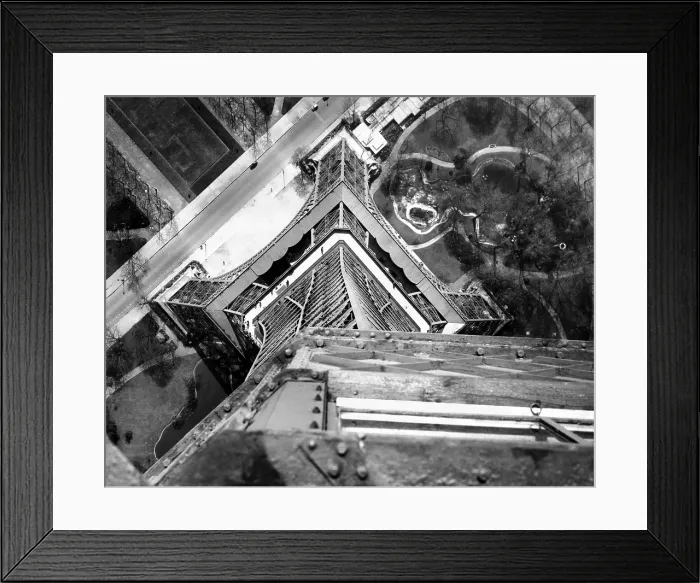 Framed Print : View to the ground from the heights of the Eiffel Tower. Looking down from the third platform shows a maze of steel and the Champ de Mars Gardens. April 16, 1951 Framed Print : View to the ground from the heights of the Eiffel Tower. Looking down from the third platform shows a maze of steel and the Champ de Mars Gardens. April 16, 1951