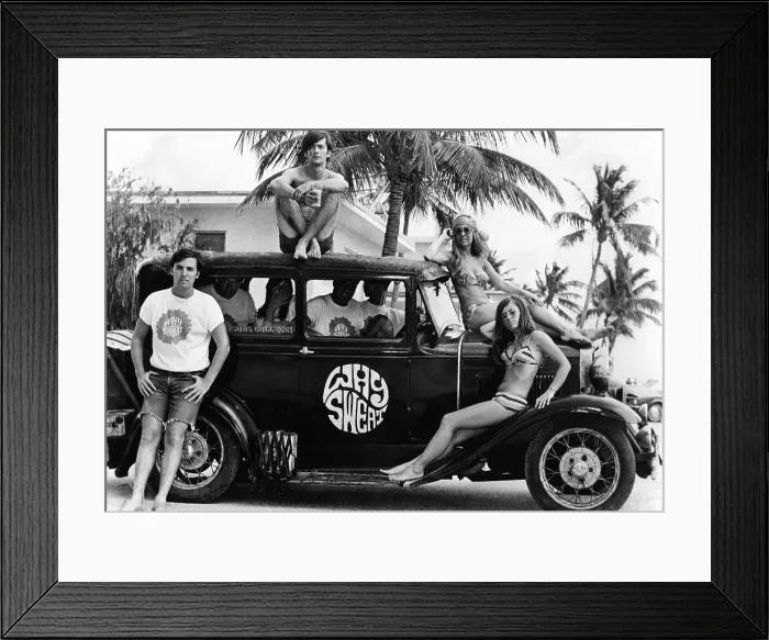 Framed Print : Students who made the spring break scene at Ft. Lauderdale pose with a 1930s roadster with a Why Sweat emblem. April 20, 1968