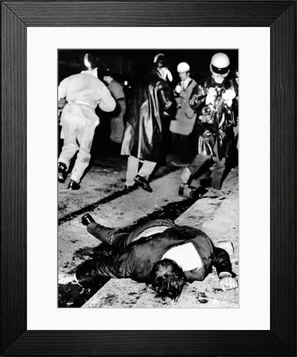 Framed Print : An injured man lies in the gutter as police battle rioting youths in Paris Latin Quarter. An estimated 6, 000 youths were involved in the clashes with police. May 23, 1969