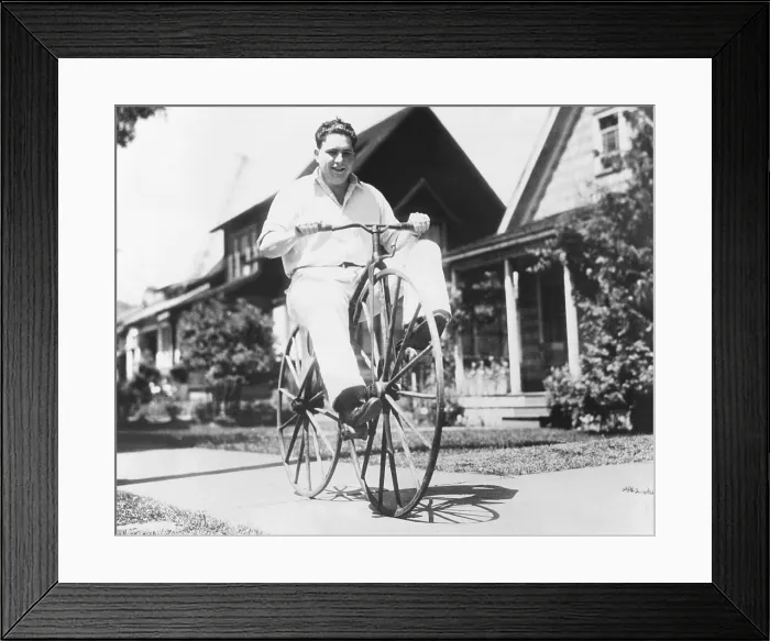 Framed Print : Dwight Hardwick riding a hand made bicycle built by his grandfather in Minnesota in 1838. It is peddled on the front wheel and made with ordinary buggy wheels
