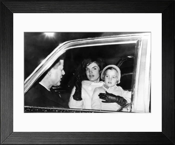 Framed Print : President John and Jacqueline Kennedy in a limousine with their four year old daughter Caroline
