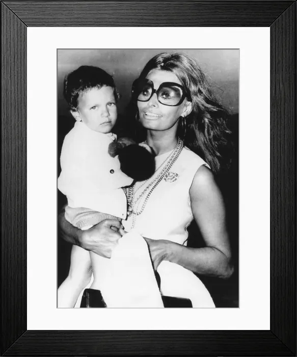 Framed Print : Sophia Loren holds her son, Carlo Ponti, Jr. at Rome's Leonardo da Vinci Airport. July 31, 1970 (CSU_2015_8_615) Framed Print : Sophia Loren holds her son, Carlo Ponti, Jr. at Rome's Leonardo da Vinci Airport. July 31, 1970 (CSU_2015_8_615)