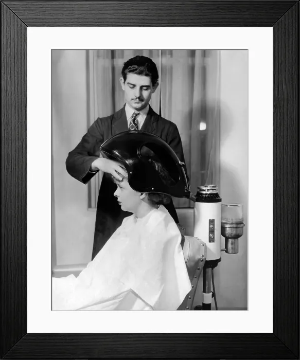 Framed Print : Helena Rubenstein Fifth Avenue Salon. Client under the scalp steamer where balsam oil forced into the scalp and hair. It helps make permanent curls soft and brilliant. March 1937