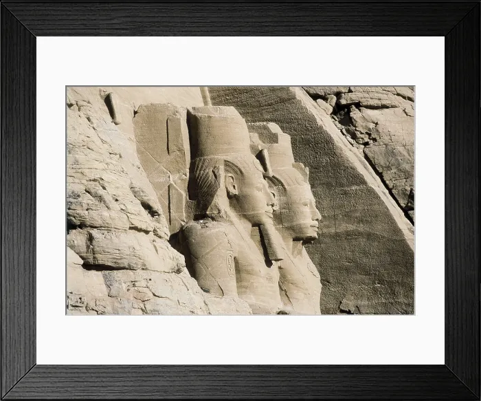 Framed Print : Great Temple of Rameses II. EGYPT. ASWAN. Abu Simbel. Great Temple of Rameses II. Upper section of two of the four colossus that flank the entrance to the Great Temple