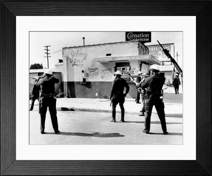 Framed Print : 1965 Watts Riot. Police and National Guardsmen hold guns ready as the sweep down San Pedro Street in a major riot torn area in Southeast Los Angeles. August 14, 1965