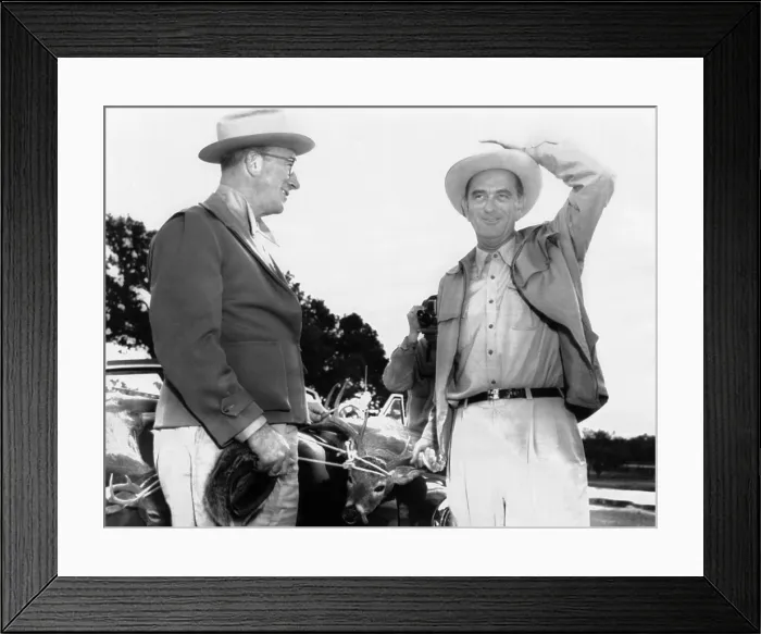 Framed Print : President Lyndon Johnson entertains Senator Estes Kefauver at the LBJ Ranch. There are two dead deer tied to the car behind them, trophies from their hunt. Nov. 23, 1955