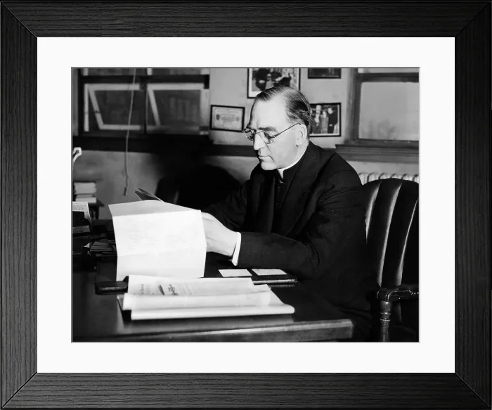 Framed Print : Father Edward J. Flanagan, founder and director of Father Flanagan's Boy's Home at Boys Town, Nebraska, is shown at his desk. Ca. 1935 Framed Print : Father Edward J. Flanagan, founder and director of Father Flanagan's Boy's Home at Boys Town, Nebraska, is shown at his desk. Ca. 1935