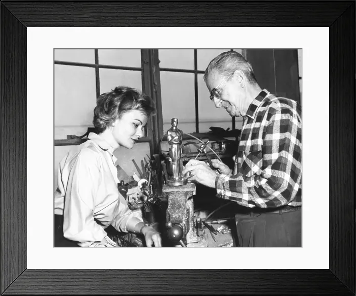 Framed Print : Actress Dodie Heath watches craftsmen Alex Smith make an Academy Award Oscar. At the Dodge trophy company in Los Angeles, ca. 1959 Framed Print : Actress Dodie Heath watches craftsmen Alex Smith make an Academy Award Oscar. At the Dodge trophy company in Los Angeles, ca. 1959