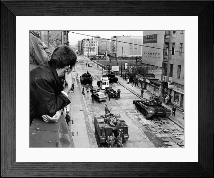 Framed Print : American tanks at the Friedrichstrasse checkpoint crossing through the Berlin Wall. A man looks down from a window at U.S. tanks and troops at Checkpoint Charlie. Oct. 25, 1961