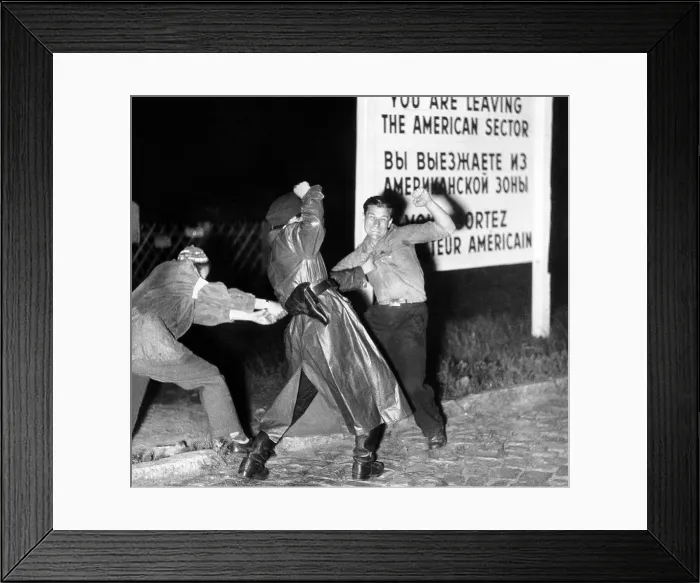 Framed Print : Violent clash between an East German policeman and his accomplice (left) as they seize a youth who tried to flee across the border into the American sector of West Berlin. Ca