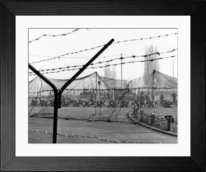 Framed Print : East Germany reinforces the concrete Berlin Wall. More barbed was strung on top of the wall Framed Print : East Germany reinforces the concrete Berlin Wall. More barbed was strung on top of the wall