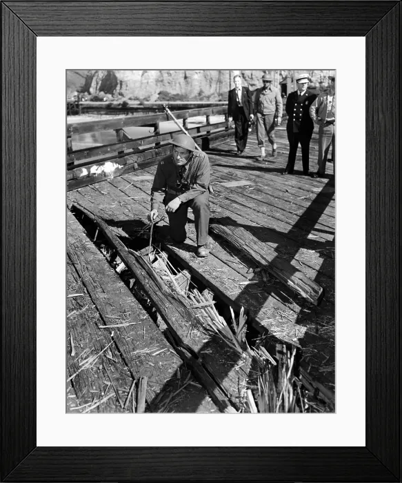 Framed Print : The Santa Barbara oil field was shelled by a Japanese submarine. A soldier examines a path grooved in an ocean pier aimed at the oil field