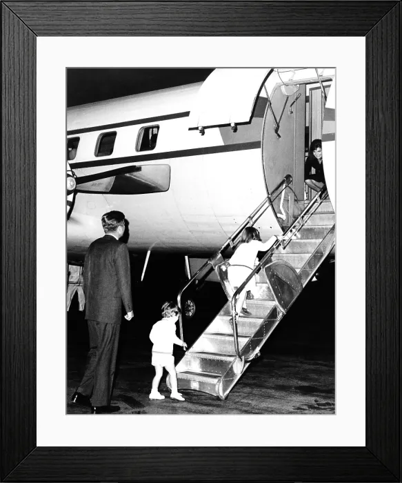 Framed Print : Jacqueline Kennedy is welcomed home by her family after her two week Mediterranean and Moroccan vacation as a guest on Aristotle Onassis's yacht. Oct. 17, 1963