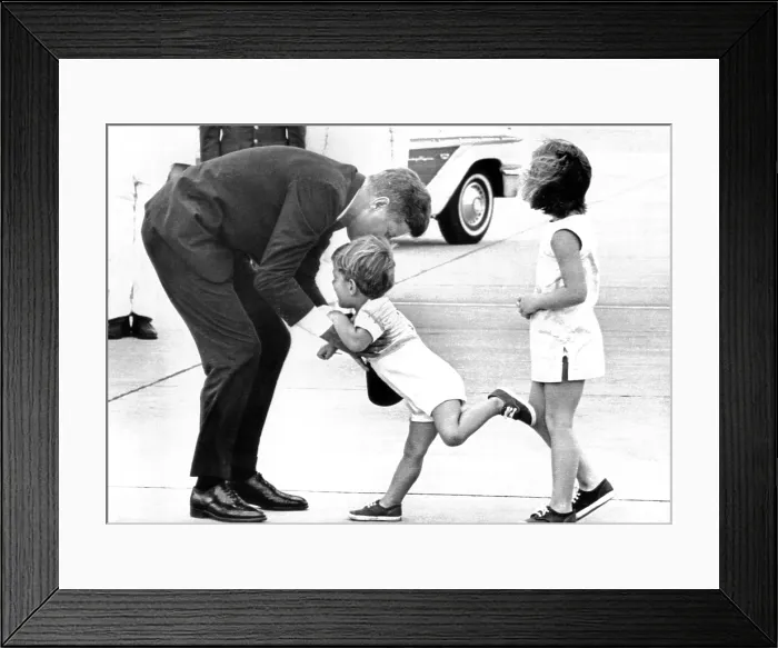 Framed Print : President John Kennedy is greeted by his children, John Jr. and Caroline on his arrival to weekend at Squaw Island, Massachusetts. Aug. 23, 1963