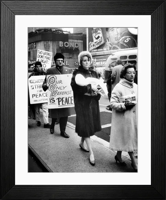 Framed Print : A Mother carries her baby as she participates in a pacifist demonstration. Women's Direct Action, maintained daily vigils at Times Square to end to nuclear testing. Feb
