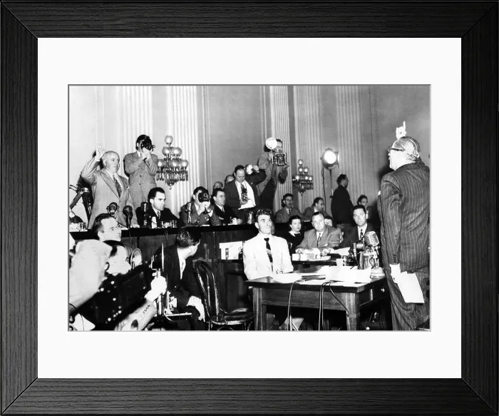 Framed Print : Screen actor Adolphe Menjou (right) is sworn in to testify before HUAC