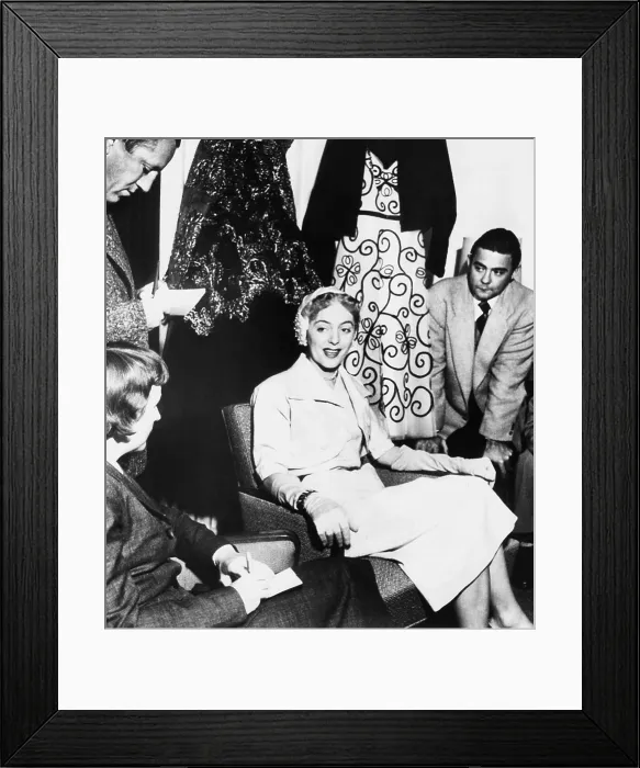 Framed Print : Christine Jorgensen, displays her night club act wardrobe at a press conference. She expressed discomfort at being turned into a joke, and being considered a freak Framed Print : Christine Jorgensen, displays her night club act wardrobe at a press conference. She expressed discomfort at being turned into a joke, and being considered a freak