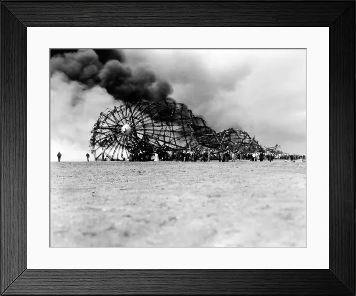 Framed Print : Hindenburg crash at Lake Hurst, New Jersey. The skeleton of the still burning Zeppelin on the ground after bursting in flames while landing. May 6, 1937