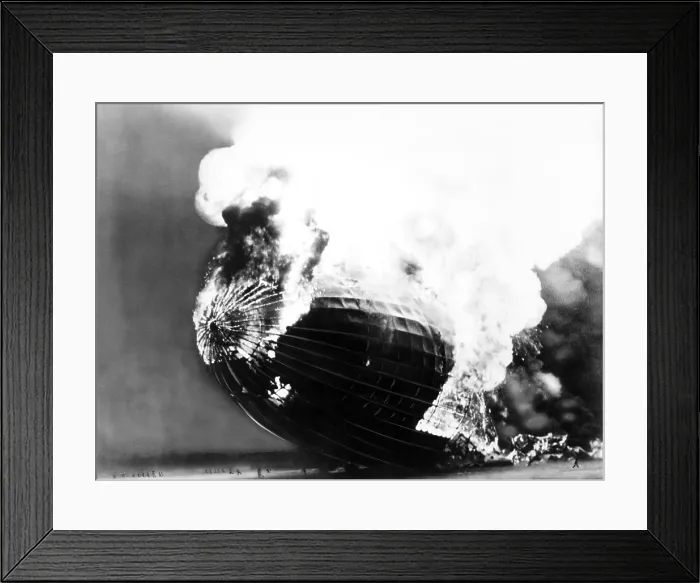 Framed Print : The Hindenburg disaster. People run away from the burning dirigible, dwarfed by its huge scale. May 6, 1937 Framed Print : The Hindenburg disaster. People run away from the burning dirigible, dwarfed by its huge scale. May 6, 1937