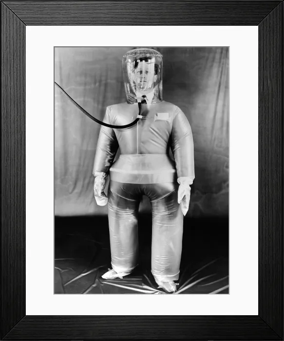 Framed Print : Plastic protective outfit filled with compressed air. It was designed to protect British Atomic energy workers against radioactive dust and particles. Oct. 21, 1954 Framed Print : Plastic protective outfit filled with compressed air. It was designed to protect British Atomic energy workers against radioactive dust and particles. Oct. 21, 1954