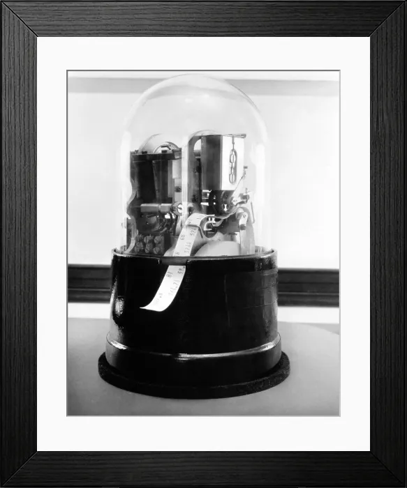 Framed Print : Classic 1920's stock ticker with a glass dome. Stock tickers were specialized telegraphs that conveying stock prices. Ca. 1915-1930 Framed Print : Classic 1920's stock ticker with a glass dome. Stock tickers were specialized telegraphs that conveying stock prices. Ca. 1915-1930