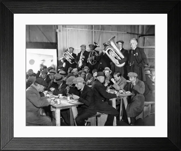 Framed Print : Municipal Lodging House Thanksgiving dinner. The hungry and destitute of New York City eat their free thanksgiving dinner accompanied by a brass band. Nov. 28, 1932
