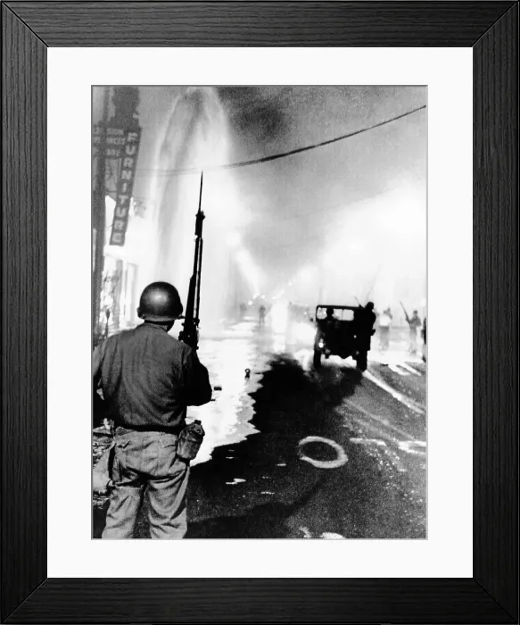 Framed Print : National Guard in Watts during the 1965 race riot. Debris litters the streets and a geyser from broken fire hydrant sprays at left. August 14, 1965 Framed Print : National Guard in Watts during the 1965 race riot. Debris litters the streets and a geyser from broken fire hydrant sprays at left. August 14, 1965