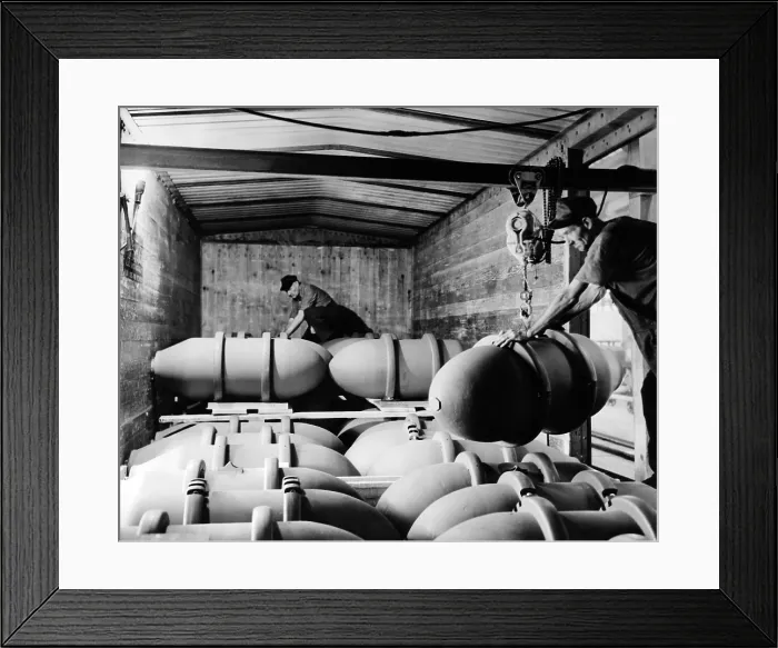 Framed Print : War workers at Blaw-Knox Company's Bomb Finishing Plant load 1, 000-pound general purpose bombs into a freight cars. Nov. 27, 1943