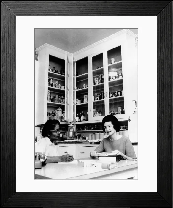 Framed Print : Lady Bird Johnson, in the kitchen with her African American cook, Zephyr Wright. Then the wife of the Vice President Lyndon Johnson, she was planning for a formal dinner