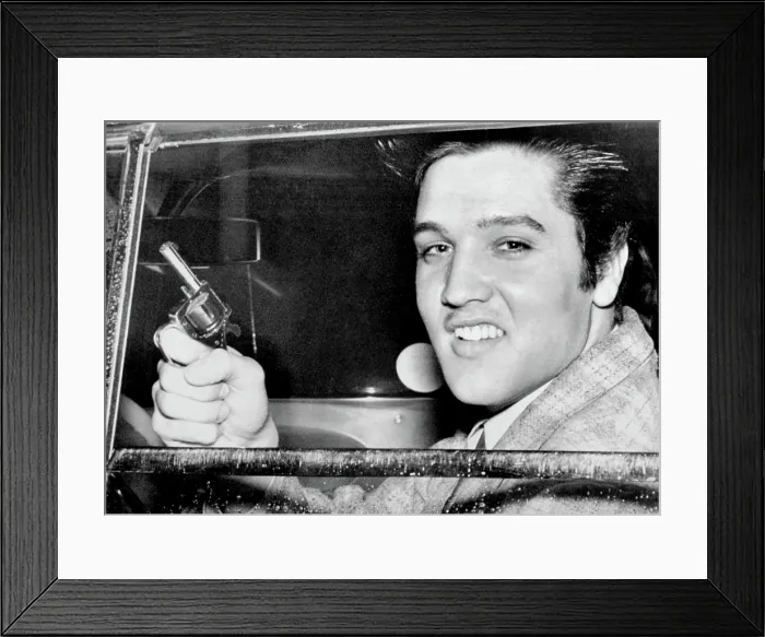 Framed Print : Elvis Presley holding the toy pistol he claimed he used in settling dispute with Marine Private Hershel Nixon, who claims Presley pulled a real gun, 1957 Framed Print : Elvis Presley holding the toy pistol he claimed he used in settling dispute with Marine Private Hershel Nixon, who claims Presley pulled a real gun, 1957