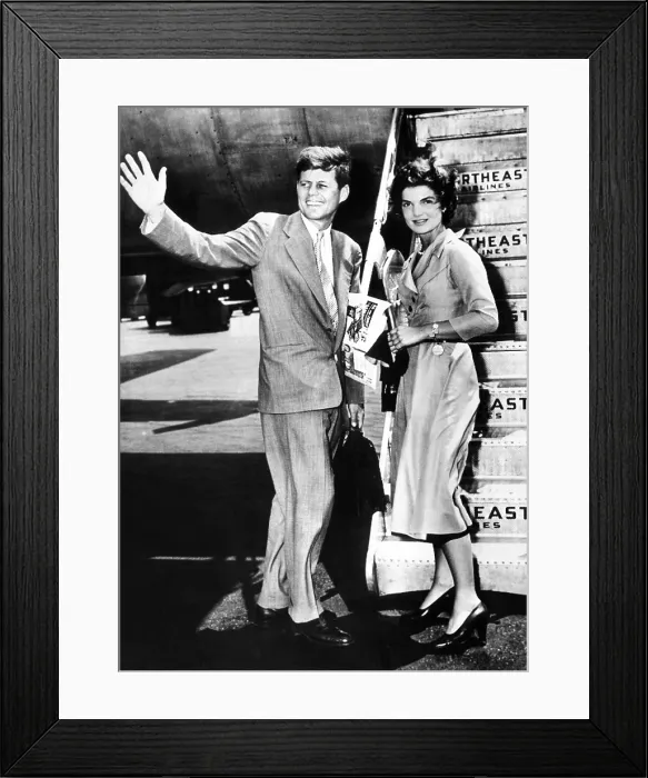 Framed Print : Sen. John Kennedy, waves as he and his fiance, Washington newspaperwoman, Jacqueline Bouvier, leave LaGuardia Airport weekend of sailing in Hyannis, Mass. June 26, 1953