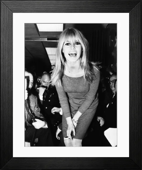 Framed Print : Brigitte Bardot poses for newsmen after her arrival at JFK Airport in New York City. Dec. 16, 1965 Framed Print : Brigitte Bardot poses for newsmen after her arrival at JFK Airport in New York City. Dec. 16, 1965