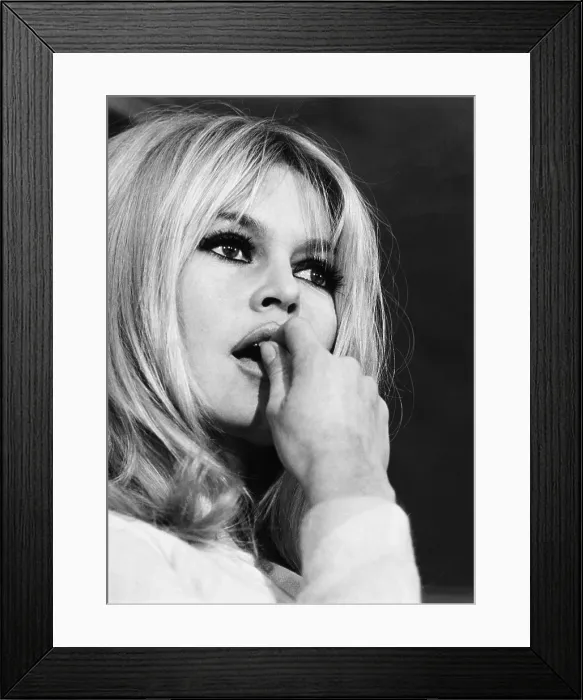 Framed Print : French actress Brigitte Bardot considers newsmen's questions at a Plaza Hotel press conference. Dec. 17, 1965