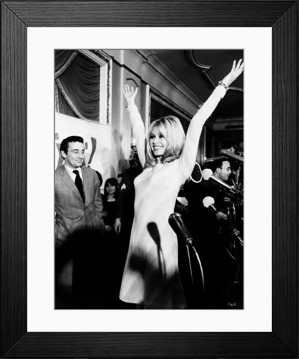 Framed Print : Brigitte Bardot shows her form for newsmen at her press conference at the Plaza Hotel. Dec. 17, 1965