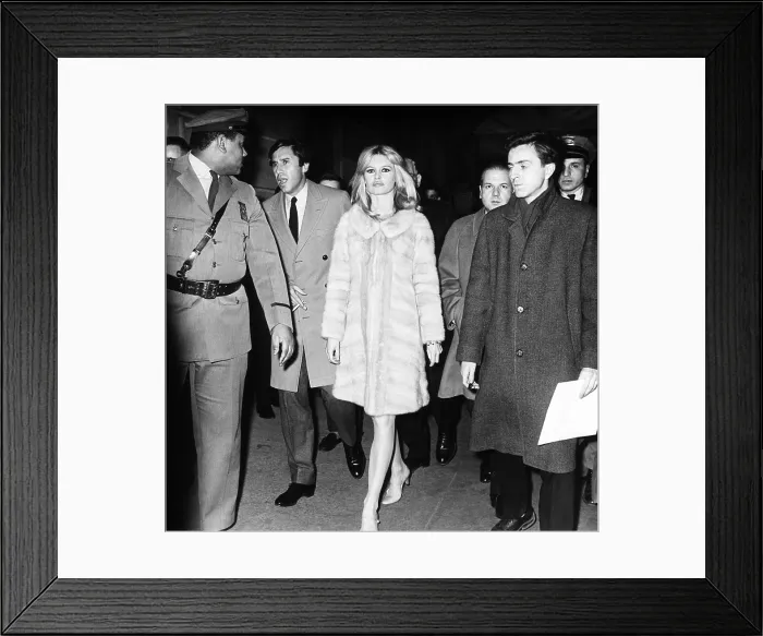 Framed Print : Brigitte Bardot and her party venturing out of the Plaza Hotel, Dec. 17, 1965. She visited New York to attend the American premiere of her latest movie, VIVA MARIA