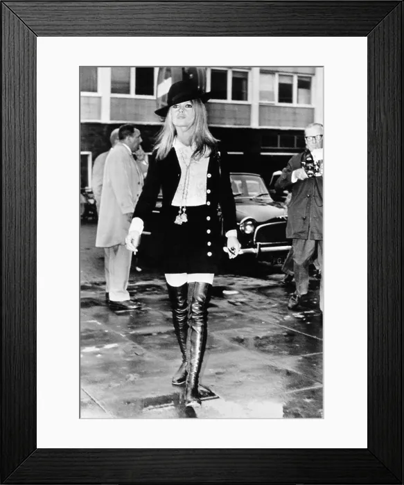 Framed Print : Brigitte Bardot in a miniskirt, and thigh high boots and a Bonnie and Clyde style wide brimmed hat. She was arriving in London to work on her latest film. April 22, 1968 Framed Print : Brigitte Bardot in a miniskirt, and thigh high boots and a Bonnie and Clyde style wide brimmed hat. She was arriving in London to work on her latest film. April 22, 1968