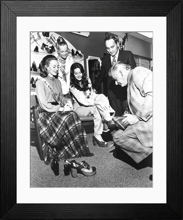 Framed Print : Not so glamourous work for Beauty Queens. Three beauty contestants promote Royce Shoes in an Endicott Johnson store in Binghamton, New York. Oct. 1973
