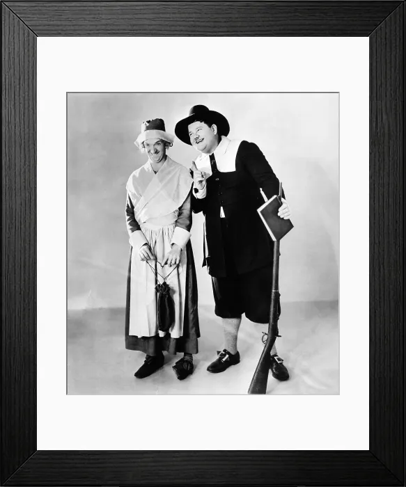 Framed Print : From left: Stan Laurel and Oliver Hardy in a Thanksgiving-themed MGM publicity shot, early 1930s