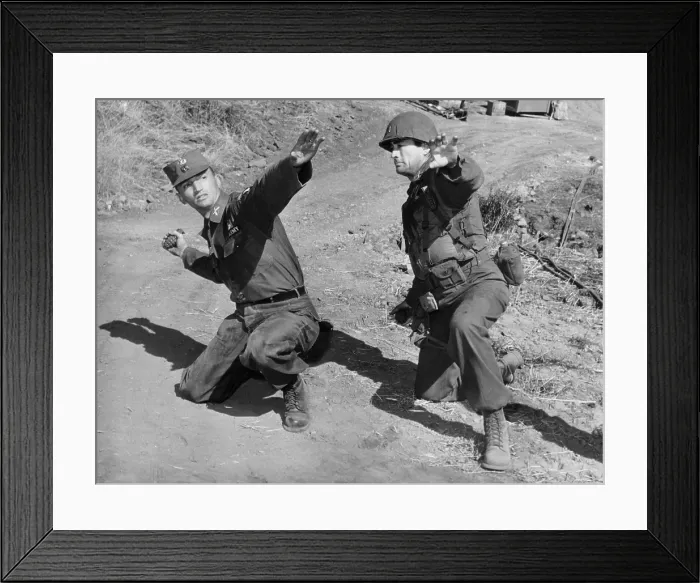 Framed Print : Actor Gregory Peck (right) gets a lesson in hand grenade throwing from Army Capt. Joseph Clemons. Peck was playing the part of Lt Framed Print : Actor Gregory Peck (right) gets a lesson in hand grenade throwing from Army Capt. Joseph Clemons. Peck was playing the part of Lt