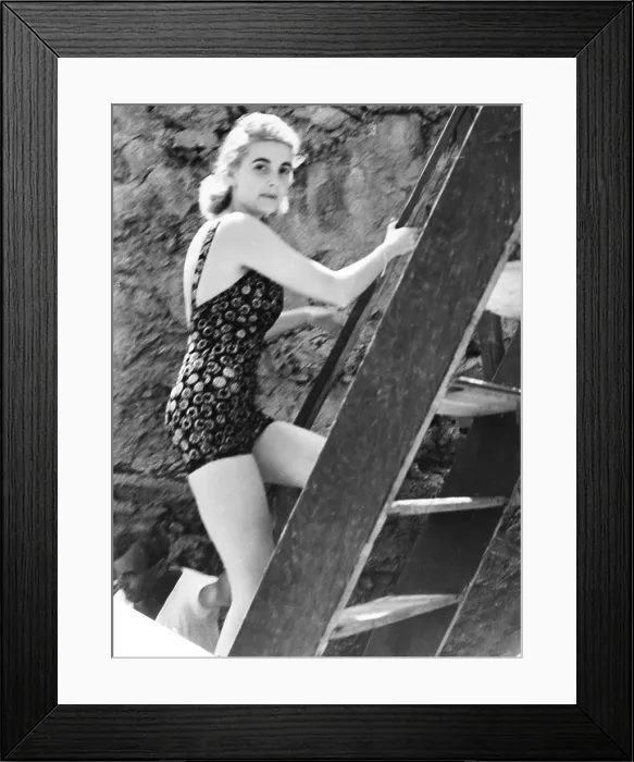 Framed Print : Barbara Hutton, now Countess Von Haugwitz-Reventlow, summering on Capri, Italy. She leased the Villa Lo Smeraldo and is climbing a ladder after a dip in the Mediterranean. Aug