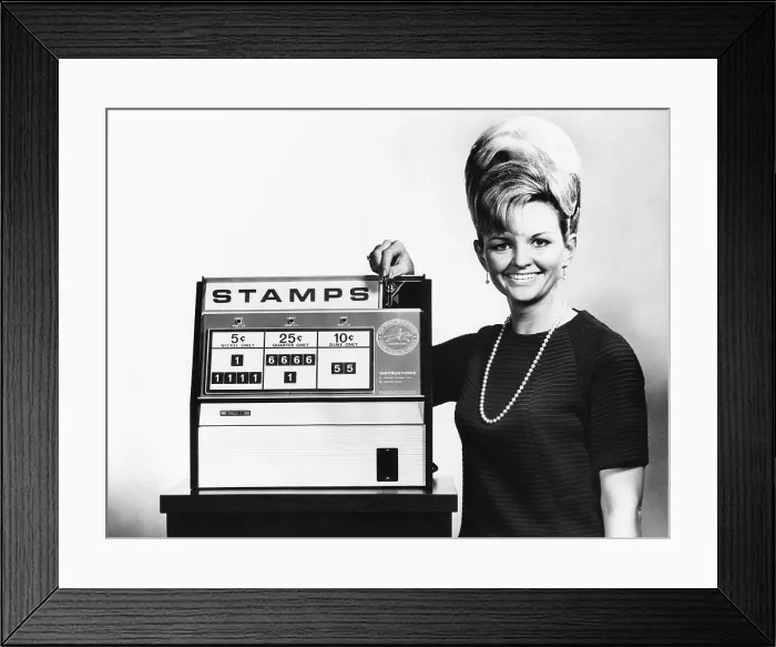 Framed Print : New Post Office Department stamp vending machine to be tested in Washington D.C. Betty Johnson, inserts a quarter in the stamp vending machine. Feb. 7, 1968. (CSU_2015_7_391)