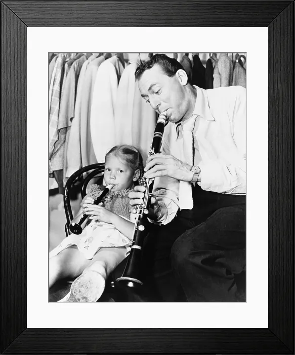 Framed Print : Jazz musician Woody Herman playing his clarinet while his daughter Ingrid plays a plastic flute. Ingrid grew up to become a Bluegrass musician and fiddler. Ca. 1946 Framed Print : Jazz musician Woody Herman playing his clarinet while his daughter Ingrid plays a plastic flute. Ingrid grew up to become a Bluegrass musician and fiddler. Ca. 1946