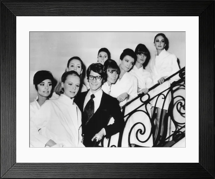 Framed Print : French fashion designer Yves Saint Laurent with models showing his 1967 spring summer collection. The models are made-up and in their smocks before the collection showing Framed Print : French fashion designer Yves Saint Laurent with models showing his 1967 spring summer collection. The models are made-up and in their smocks before the collection showing