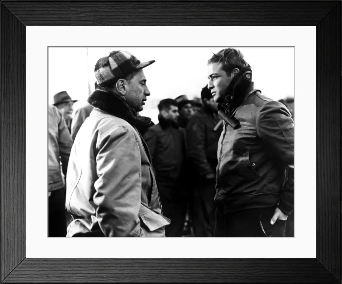 Framed Print : ELIA KAZAN directs MARLON BRANDO on location during production of ON THE WATERFRONT, 1954