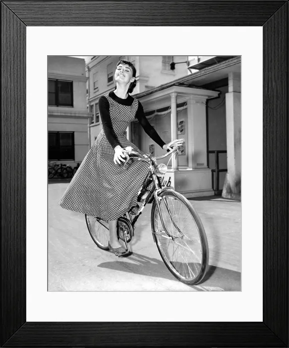 Framed Print : AUDREY HEPBURN bicycles to soundstage where she is filming SABRINA, 1954 Framed Print : AUDREY HEPBURN bicycles to soundstage where she is filming SABRINA, 1954