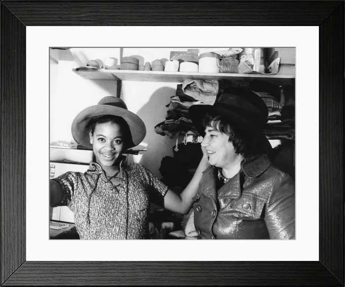 Framed Print : A high school student tries on one of Bella Abzug's wide brimmed campaign hats
