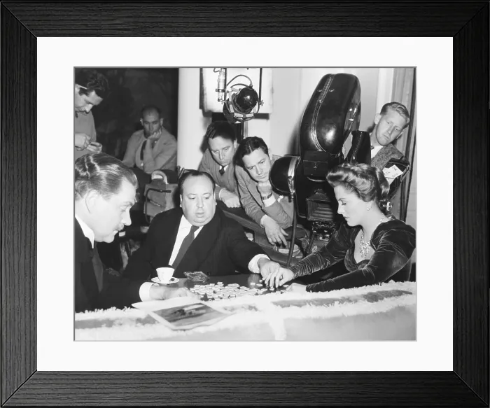 Framed Print : Director Hitchcock directing a scrabble scene with Joan Fontaine in SUSPICION. 1914. With Nigel Bruce, Fontaine's character plays scrabble as the film crew looks Framed Print : Director Hitchcock directing a scrabble scene with Joan Fontaine in SUSPICION. 1914. With Nigel Bruce, Fontaine's character plays scrabble as the film crew looks