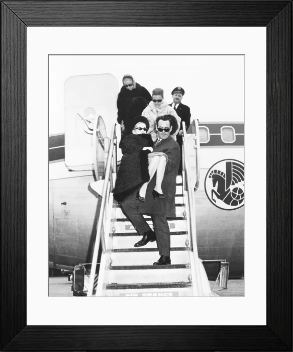 Framed Print : Barbara Hutton is carried off an Air France by her companion, Colin Fraser. At Kennedy Airport, Dec. 5, 1966