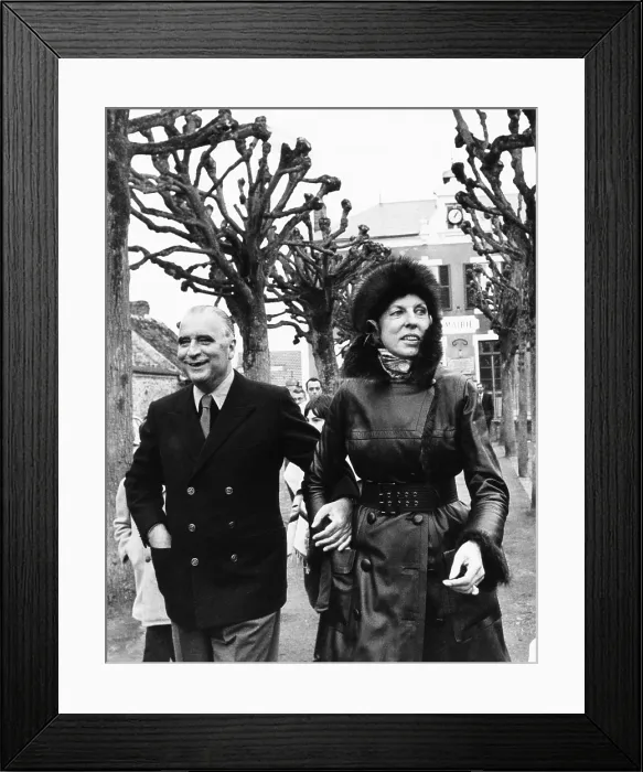 Framed Print : French President and Claude Pompidou arriving to vote in the French municipal elections. March 14, 1971. Mme. Pompidou wears a fashionable mink fur hat and leather coat